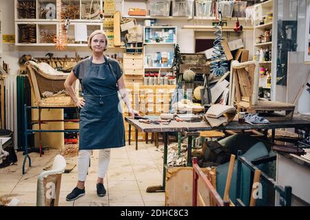 Portrait of female craftsperson standing in upholstery workshop Stock Photo