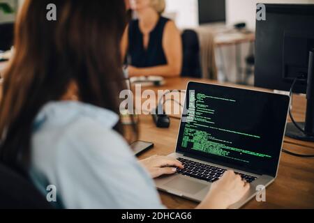 Female computer programmer working at desk in creative office Stock Photo