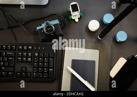 Directly above shot of various technologies and diaries on desk in office Stock Photo