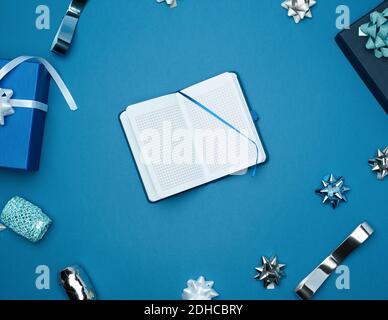 Open notebook with empty white sheets, blue background with box Stock Photo