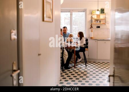 Family having meal together in kitchen at home Stock Photo