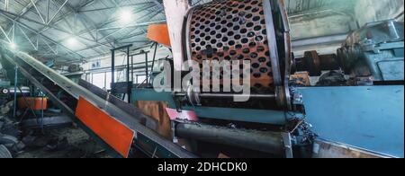 Rubber recycling processing factory, industrial equipment and conveyor line with cut used car tires. Recycling waste. Stock Photo