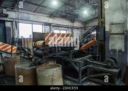 Rubber recycling processing factory, industrial equipment and conveyor line with cut used car tires. Recycling waste. Stock Photo