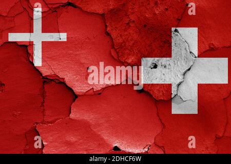 Flags of Schwyz canton and Switzerland painted on cracked wall Stock Photo