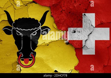 Flags of Uri canton and Switzerland painted on cracked wall Stock Photo