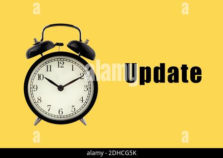 UPDATE text with alarm clock on yellow background. Business Concept Stock Photo