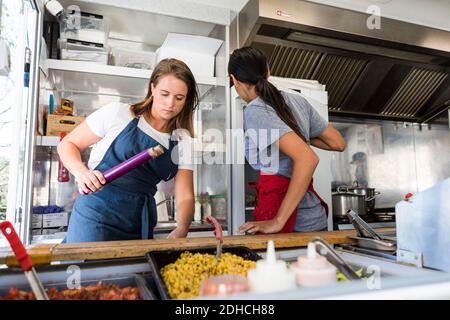 Multi-ethnic female colleagues working in food truck Stock Photo