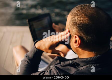 High angle view of man using digital tablet at patio Stock Photo