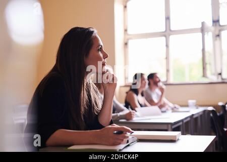 Side view of confident woman listening to lecture in language school Stock Photo