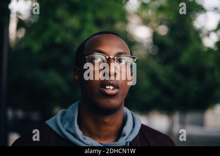 Close-up of thoughtful young man wearing eyeglasses looking away Stock Photo