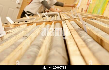A closeup of stacked drilled core samples from the minesin wooden boxes Stock Photo
