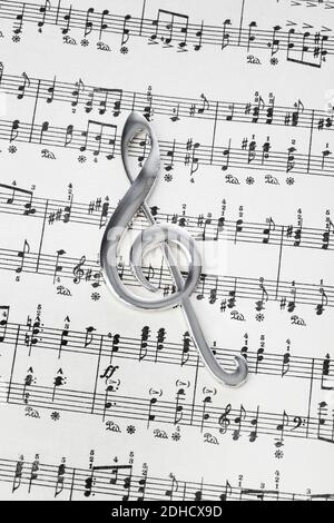 Treble clef on music sheet - musical background Stock Photo