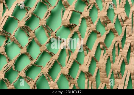 Abstract green texture with cut honeycomb brown corrugated paper Stock Photo