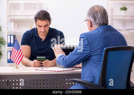 Young man visiting embassy for visa application Stock Photo