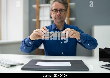 Remote Check Deposit Using Mobile Photo. Scanning Documents With Phone Stock Photo