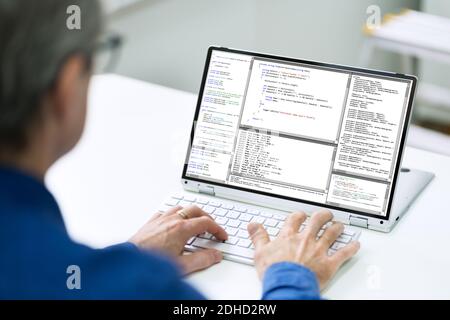 Programmer Man Coder With Code On Screen At Home Stock Photo
