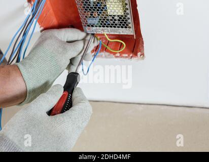 Worker is installs and connects the power supply of LED backlight. Stock Photo