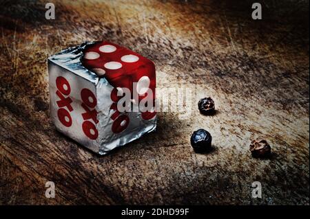 A conceptual image of a dice within a stock cube wrapper. Diced beef. Stock Photo