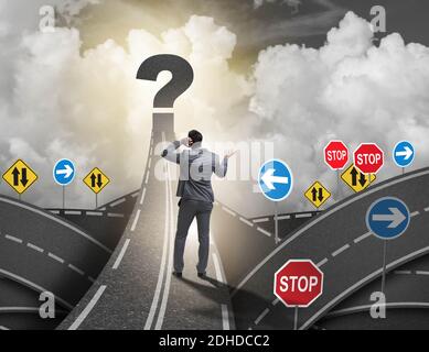 Businessman in uncertainty concept on road intersection crossroa Stock Photo