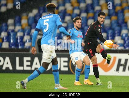 Naples, Italy. 10th Dec, 2020. Real Sociedad's Spanish midfielder Mikel Merino kicks the ball next to Napoli's belgian striker Dries Mertens during the UEFA Europa League Group F football match SSC Napoli vs Real Sociedad de Futbol. Napoli and Real Sociedad drew 1-1. Credit: Independent Photo Agency/Alamy Live News Stock Photo