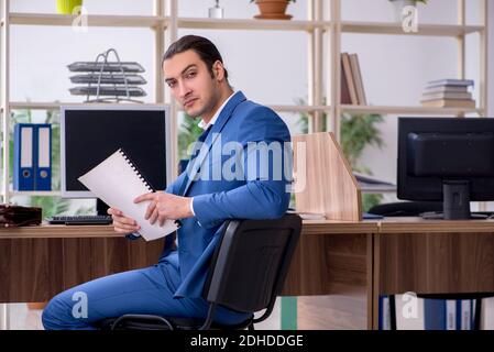 Young male employee businessman at workplace Stock Photo