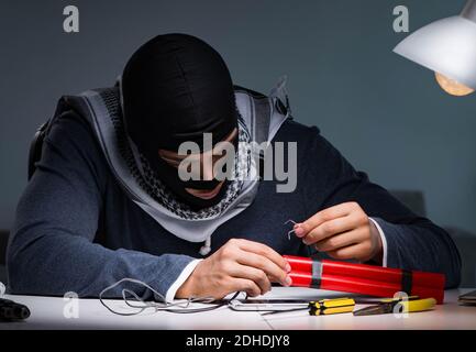 Terrorist bomber preparing dynamite bomb Stock Photo