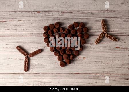 Chocolate truffles designed in heart shape with Chocolate covered cookies designed in star shapes on the sides. A sweet and delicious concept for Vale Stock Photo