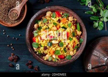 Couscous, overhead flat lay shot in a tagine with ingredients Stock Photo