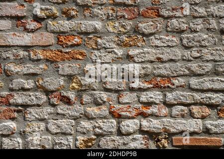 Background from a weather-beaten old red brick wall Stock Photo