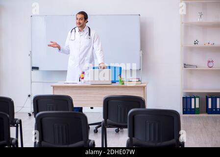 Young male doctor giving seminar in the classroom Stock Photo