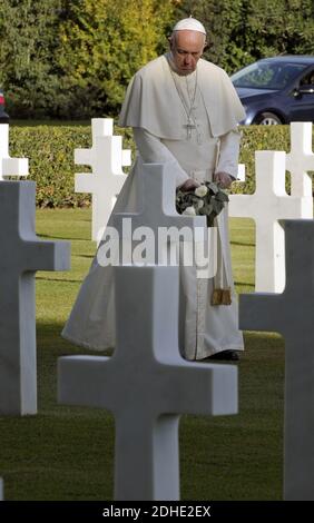 Pope Francis passes graves, before a Mass at the U.S. World War II cemetery on the day Christians around the world commemorate their dead, in Nettuno, near Rome, Italy on November 2, 2017. The burial ground is the final resting place for 7,860 American soldiers who died in the liberation of Italy in 1943 and 1944. He walked slowly and alone amid the rows of low white headstones in the shape of crosses and Stars of David, gently resting a white rose on about a dozen and stopping to pray silently. Photo by ABACAPRESS.COM Stock Photo