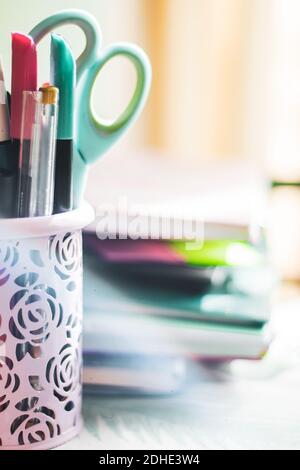 boat with pens and scissors on a table close-up Stock Photo