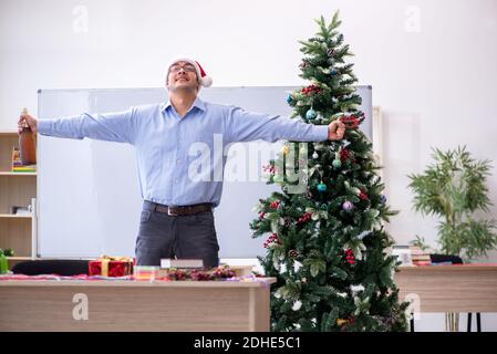 Young male teacher celebrating new year at school Stock Photo