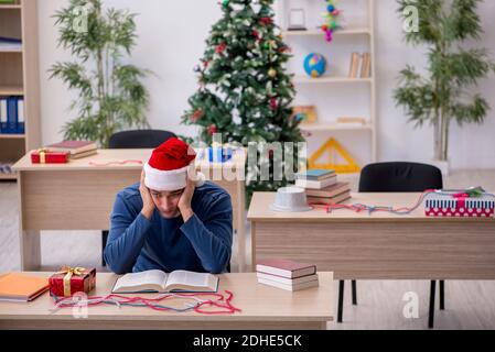 Young male student preparing for exams during new year celebrati Stock Photo