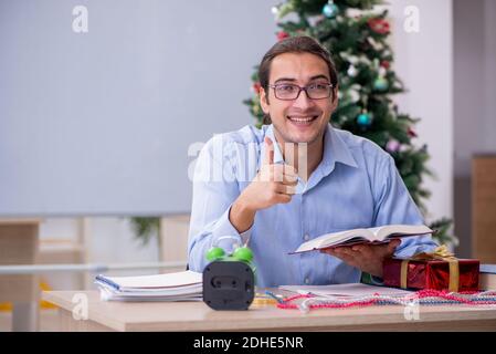 Young male teacher celebrating new year at school Stock Photo