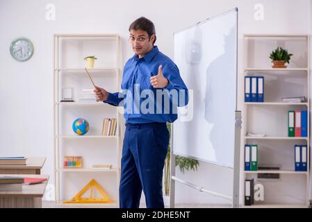 Young male teacher in front of white board Stock Photo