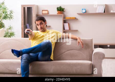 Young man student boring at home during pandemic Stock Photo