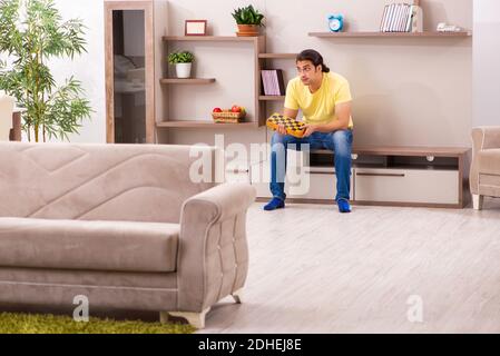 Young man student boring at home during pandemic Stock Photo