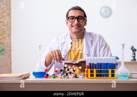 Young male chemist student in the classroom Stock Photo