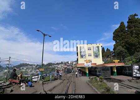 View of Darjeeling Railway Station, with Kanchenjunga and the snow-clad Himalayan ranges towering over the town in the distance Stock Photo