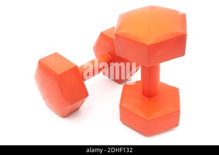 Two plastic covered orange dumbells cut out isolated on white background Stock Photo