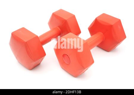 Two plastic covered orange dumbells cut out isolated on white background Stock Photo