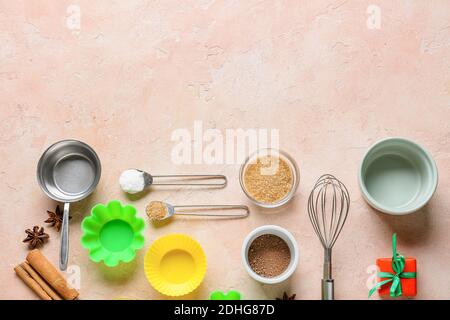 Ingredients for Christmas muffins and baking utensils on color background Stock Photo