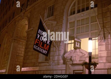 new york film academy banner is it is hanging attached to the building at night time Stock Photo