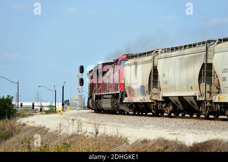 Bensenville, Illinois, USA. A pair of Canadian Pacific Railway locomotives edge a grain train upgrade out of the railroad's Bensenville Yard. Stock Photo