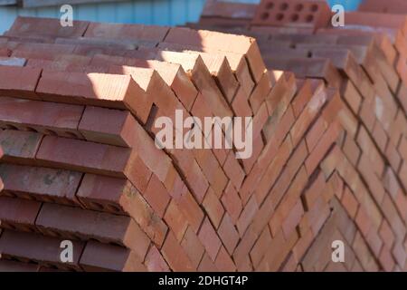 Building material - red brick folded on a pallet. Stock Photo