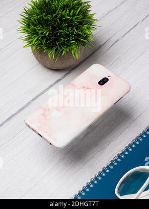 Custom phone skin flatlay with different background color. Stock Photo