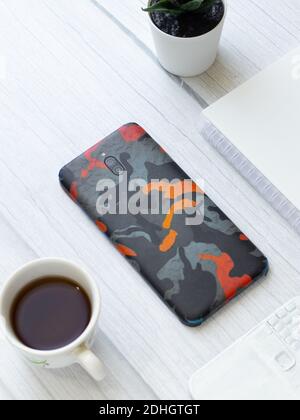Custom phone skin flatlay with different background color. Stock Photo