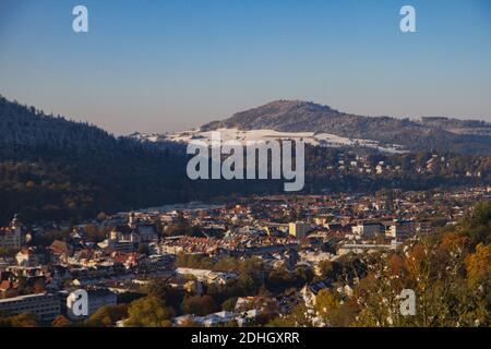 Freiburg im Breisgau, Germany - 11 09 2012: Picturesque view of the city from the mountain, snow-covered Black forest, mountains in the clouds. Stock Photo