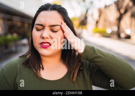 Young woman suffering from headache. Stock Photo